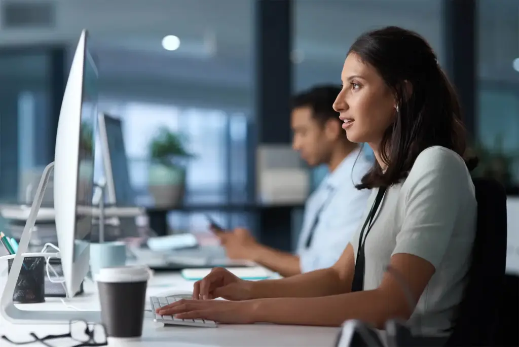 Analysts working at workstations in an office