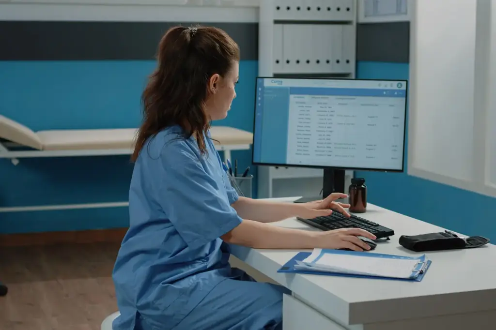Clinician working at a workstation in an exam room
