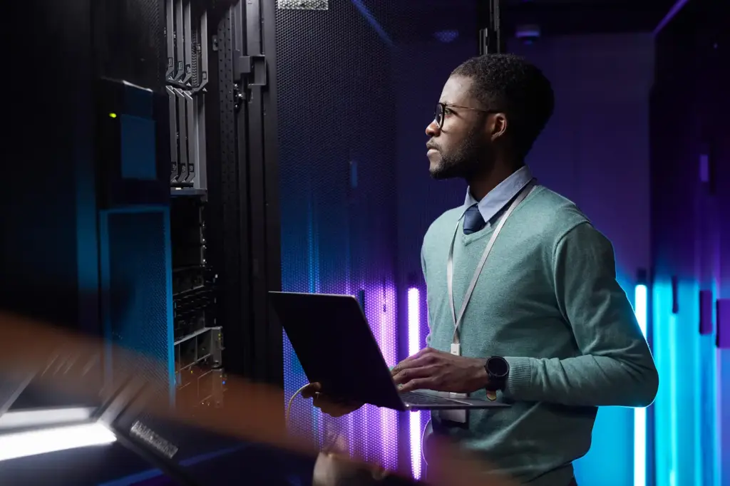 Engineer with a laptop in a data center