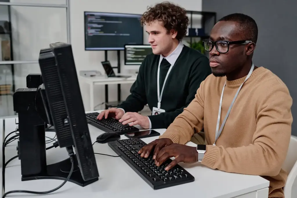 Two engineers reviewing log data at their workstations