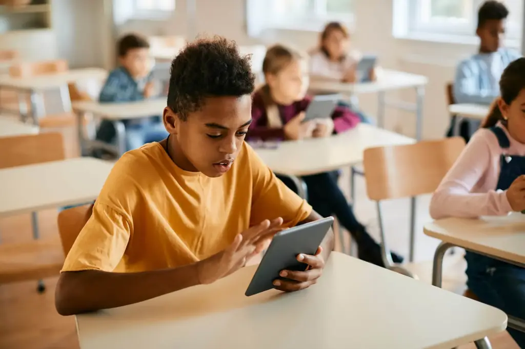 Student using a tablet in a classroom